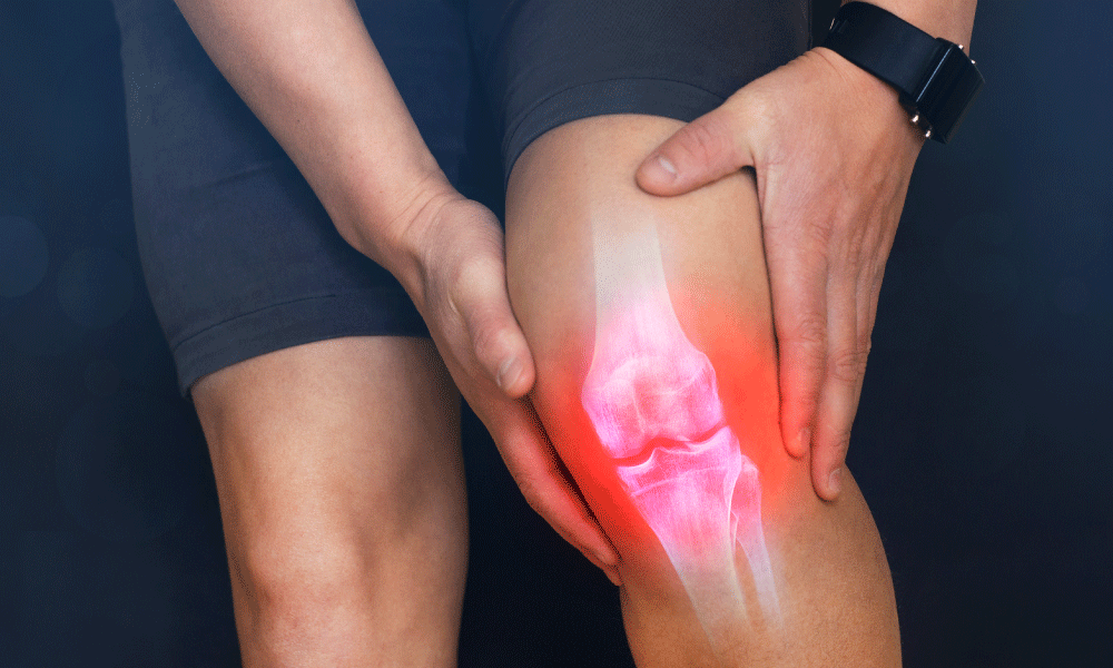 A person places their hands on their inflamed knee