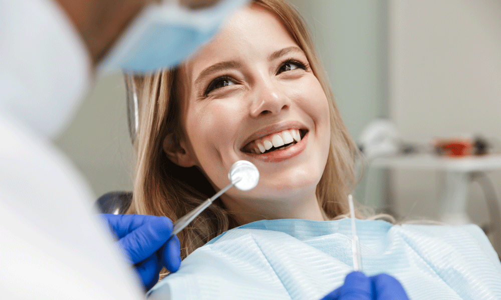A woman smiling in a dentist chair